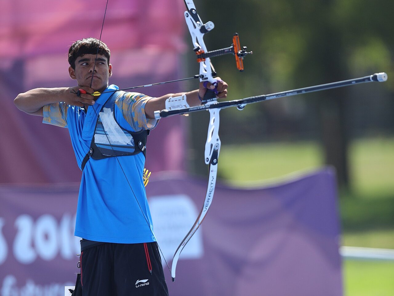 Indian archer drawing a recurve bow during a competition